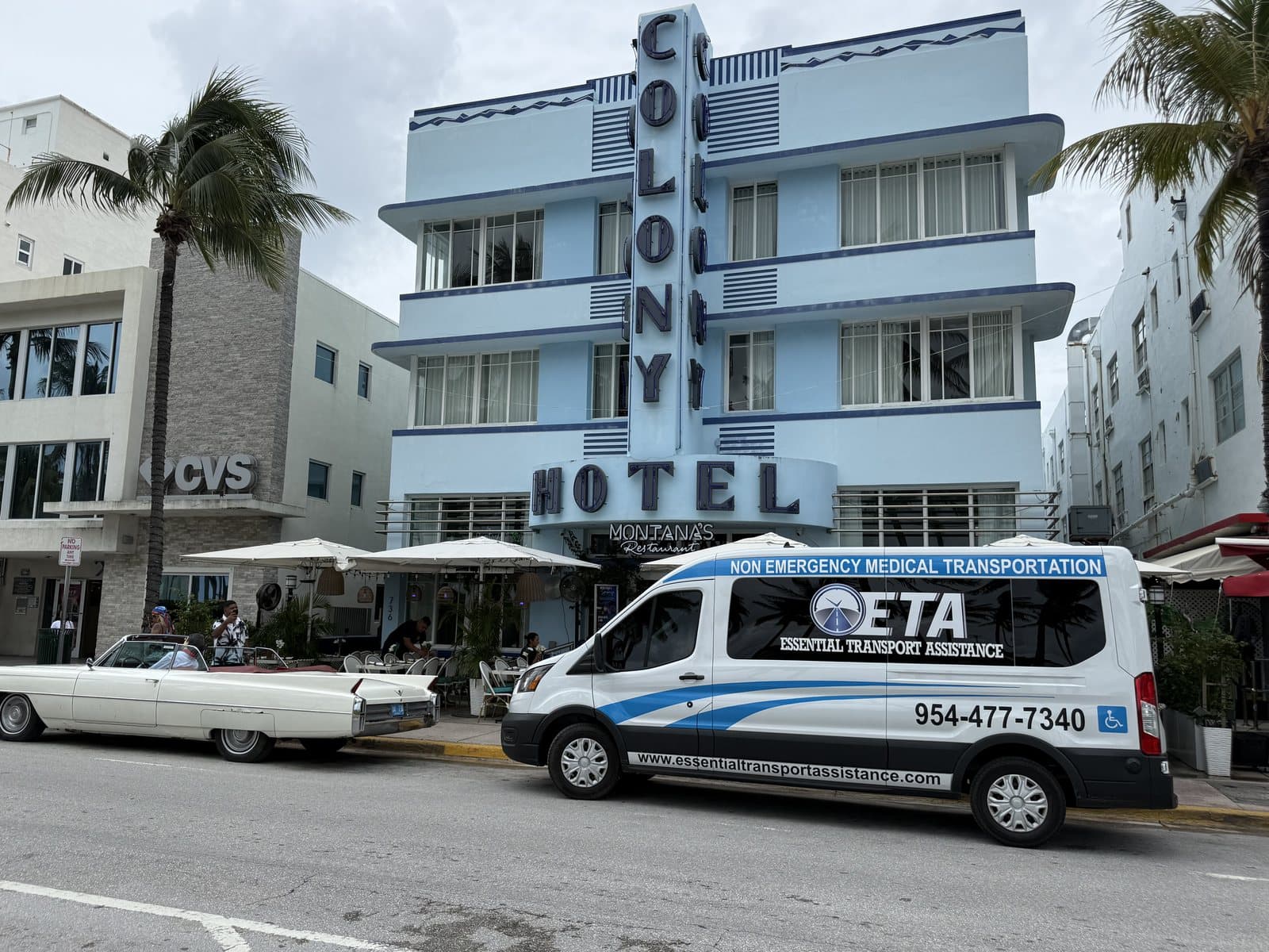 Essential Transport Assistance wheelchair-accessible van parked in front of the Colony Hotel on Ocean Drive in Miami Beach