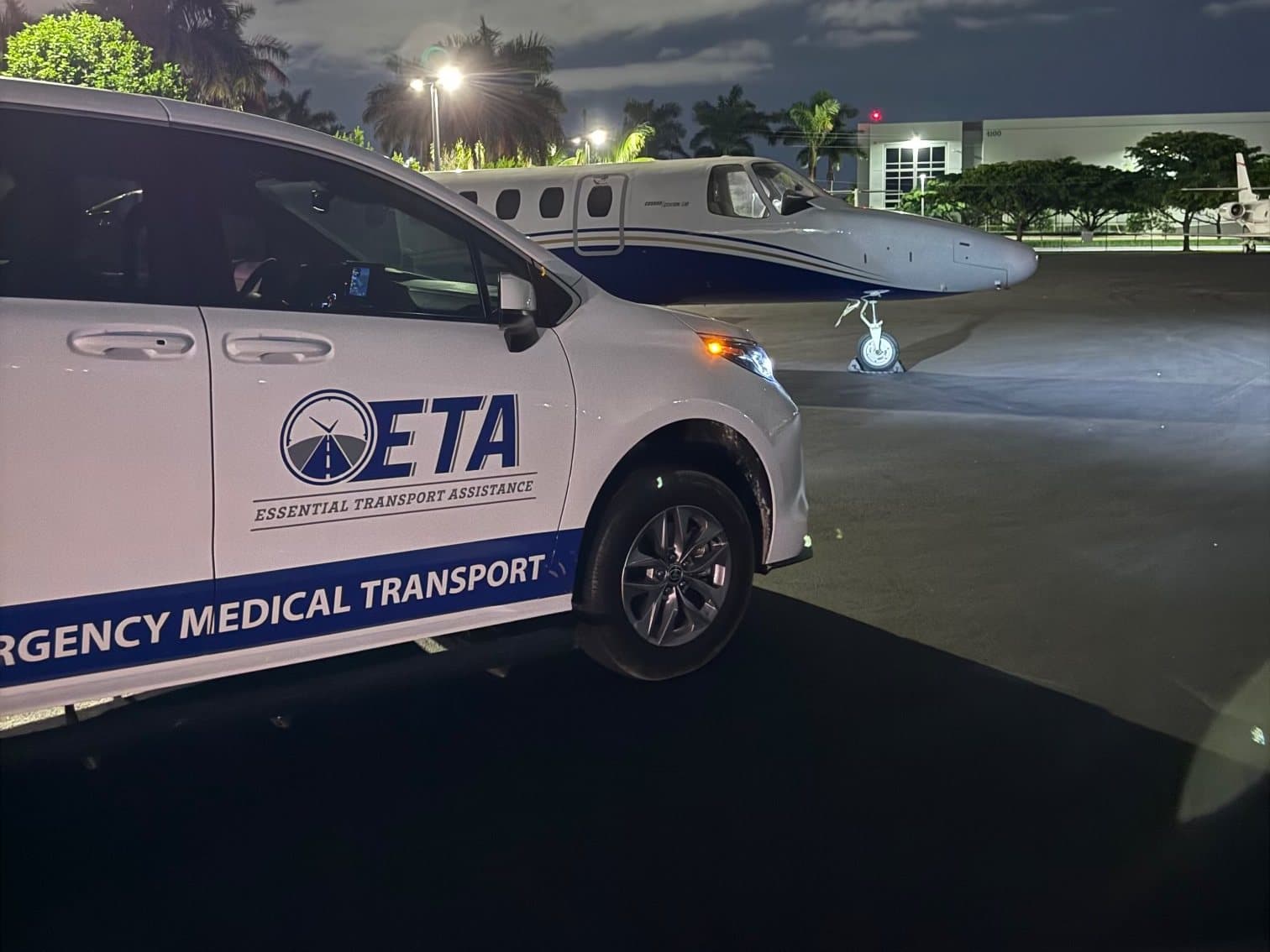 Essential Transport Assistance wheelchair-accessible minivan on the ramp beside a private jet at Opa-locka Executive Airport in Miami-Dade