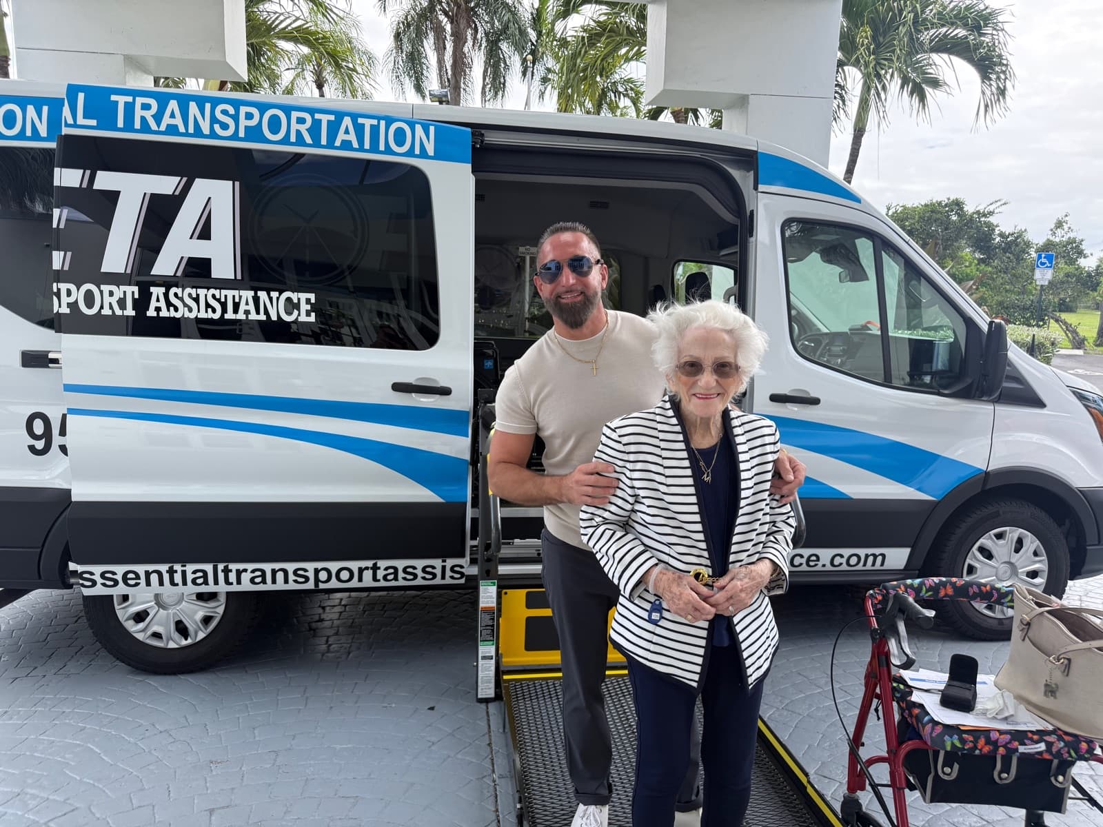 ETA team member assisting a passenger by the van — treating every passenger like family