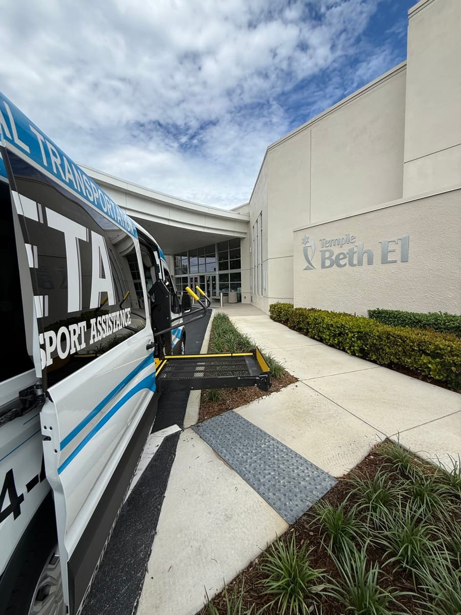 ETA wheelchair van with the lift lowered on the walkway leading to a synagogue entrance