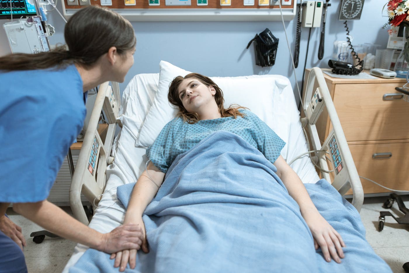 Care attendant comforting a resting patient